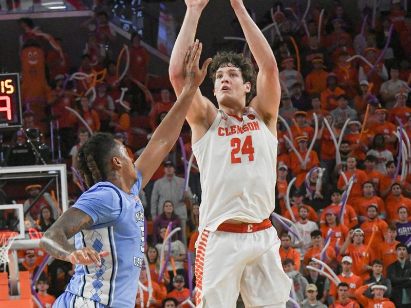 Jan 6, 2024; Clemson, South Carolina, USA;  Clemson junior forward PJ Hall (24) shoot the ball near University of North Carolina center Armando Bacot (5) during the second half at Littlejohn Coliseum. Mandatory Credit: Ken Ruinard-USA TODAY Sports