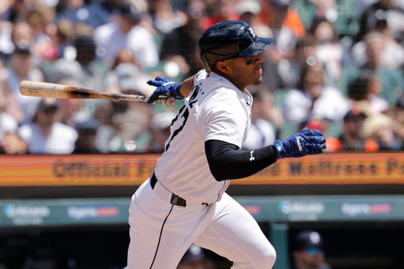 May 25, 2025; Detroit, Michigan, USA;  Detroit Tigers third base Andy Ibáñez (77) hits an RBI single in the fourth inning against the Cleveland Guardians at Comerica Park. Mandatory Credit: Rick Osentoski-Imagn Images