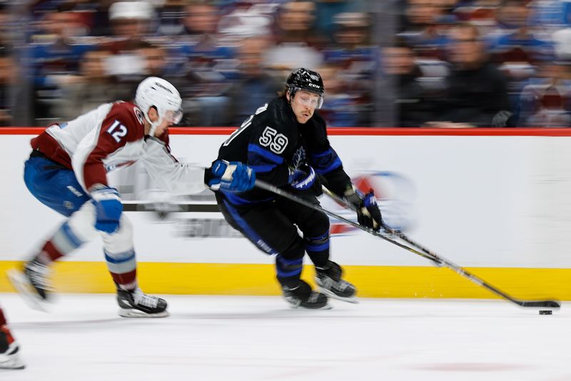 Feb 24, 2024; Denver, Colorado, USA; Toronto Maple Leafs left wing Tyler Bertuzzi (59) controls the puck against Colorado Avalanche center Ryan Johansen (12) in the first period at Ball Arena. Mandatory Credit: Isaiah J. Downing-USA TODAY Sports