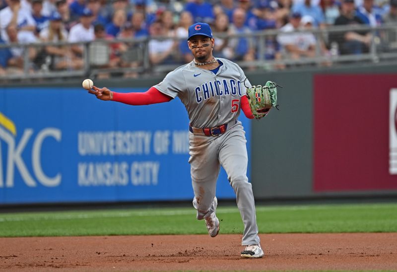 Jul 27, 2024; Kansas City, Missouri, USA;  Chicago Cubs third baseman Christopher Morel (5) throws to first base for an out against the Kansas City Royals in the first inning at Kauffman Stadium. Mandatory Credit: Peter Aiken-USA TODAY Sports