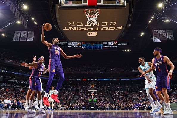 PHOENIX, AZ - DECEMBER 29: Kevin Durant #35 of the Phoenix Suns rebounds the ball during the game against the Charlotte Hornets on December 29 2023 at Footprint Center in Phoenix, Arizona. NOTE TO USER: User expressly acknowledges and agrees that, by downloading and or using this photograph, user is consenting to the terms and conditions of the Getty Images License Agreement. Mandatory Copyright Notice: Copyright 2023 NBAE (Photo by Barry Gossage/NBAE via Getty Images)