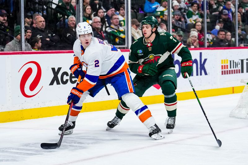 Jan 15, 2024; Saint Paul, Minnesota, USA; New York Islanders defenseman Mike Reilly (2) protects the puck from Minnesota Wild defenseman Brock Faber (7) during the third period at Xcel Energy Center. Mandatory Credit: Brace Hemmelgarn-USA TODAY Sports