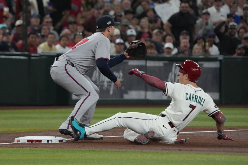 Apr 27, 2025; Phoenix, Arizona, USA; Arizona Diamondbacks outfielder Corbin Carroll (7) slides into thirdbase after hitting a triple in front of Atlanta Braves third base Austin Riley (27) in the first inning at Chase Field. Mandatory Credit: Rick Scuteri-Imagn Images