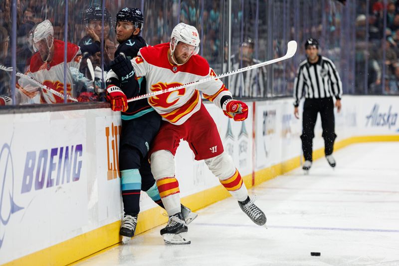 Oct 19, 2024; Seattle, Washington, USA; Calgary Flames right wing Anthony Mantha (39) collides into Seattle Kraken left wing Andre Burakovsky (95) during the third period at Climate Pledge Arena. Mandatory Credit: Caean Couto-Imagn Images