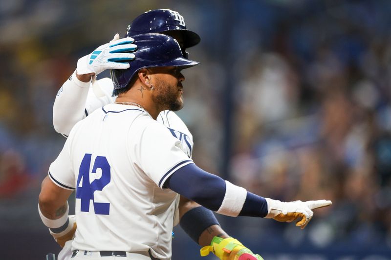 Apr 15, 2024; St. Petersburg, Florida, USA;  Tampa Bay Rays designated hitter Harold Ramírez (42) celebrates after hitting a two run home run against the Los Angeles Angels in the eighth inning during Jackie Robinson day at Tropicana Field. Mandatory Credit: Nathan Ray Seebeck-USA TODAY Sports