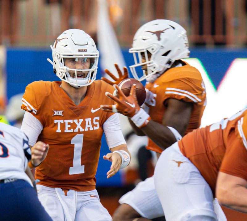 Sep 17, 2022; Austin, Texas, USA; Texas Longhorns quarterback Hudson Card (1) forwards the ball to running back Keilan Robinson (7) against the UTSA Roadrunners during the first quarter at Darrell K Royal-Texas Memorial Stadium. Mandatory Credit: John Gutierrez-USA TODAY Sports