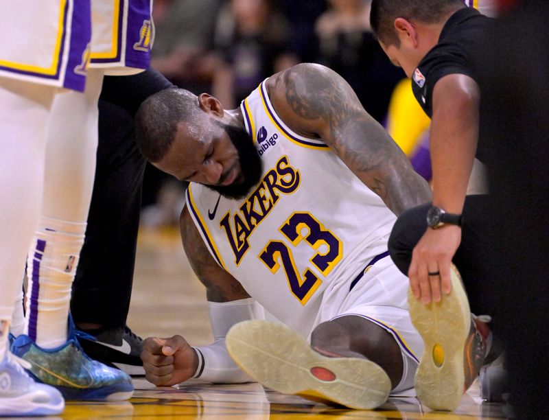 LOS ANGELES, CALIFORNIA - DECEMBER 25: LeBron James #23 of the Los Angeles Lakers grimaces in pain after a collision with Jaylen Brown #7 of the Boston Celtics in the first half at Crypto.com Arena on December 25, 2023 in Los Angeles, California. NOTE TO USER: User expressly acknowledges and agrees that, by downloading and or using this photograph, User is consenting to the terms and conditions of the Getty Images License Agreement.(Photo by Jayne Kamin-Oncea/Getty Images)