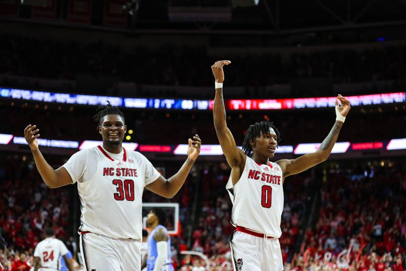 Feb 19, 2023; Raleigh, North Carolina, USA;  North Carolina State Wolfpack forward D.J. Burns Jr. (30) and guard Terquavion Smith (0) celebrate during the second half of the game against North Carolina Tar Heels at PNC Arena. Mandatory Credit: Jaylynn Nash-USA TODAY Sports