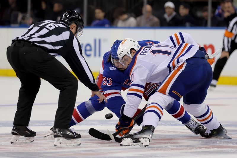 Oct 14, 2025; New York, New York, USA; New York Rangers center Mika Zibanejad (93) takes a face off against Edmonton Oilers center Trent Frederic (10) during the first period at Madison Square Garden. Mandatory Credit: Brad Penner-Imagn Images