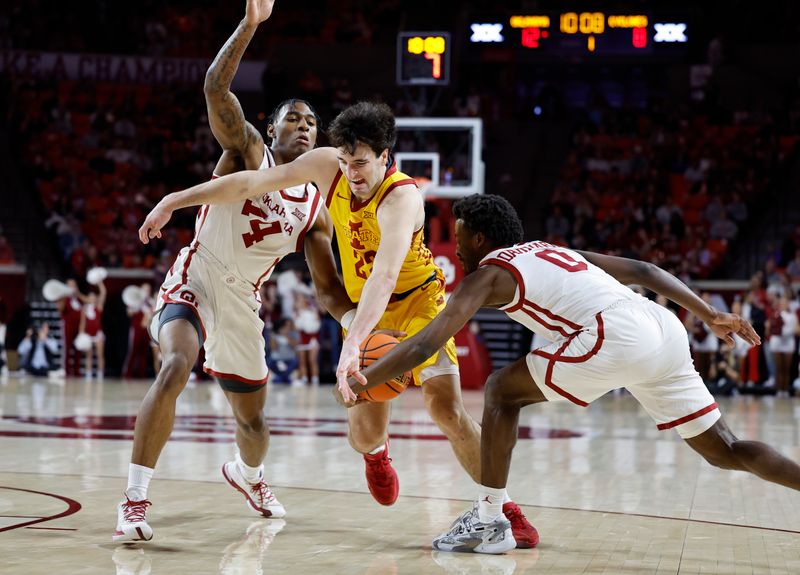 Jan 6, 2024; Norman, Oklahoma, USA; Oklahoma Sooners guard Le'Tre Darthard (0) steals the ball from Iowa State Cyclones forward Milan Momcilovic (22) on a drive during the first half at Lloyd Noble Center. Mandatory Credit: Alonzo Adams-USA TODAY Sports