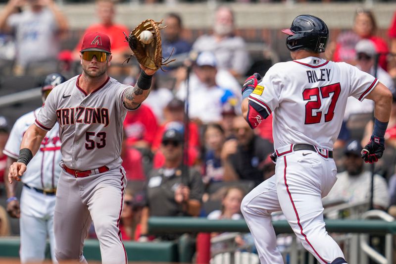 Jul 20, 2023; Cumberland, Georgia, USA; Arizona Diamondbacks first baseman Christian Walker (53) retires Atlanta Braves third baseman Austin Riley (27) at first base during the first inning at Truist Park. Mandatory Credit: Dale Zanine-USA TODAY Sports