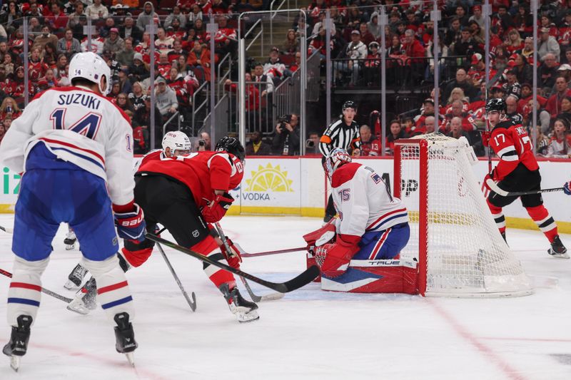 Nov 6, 2025; Newark, New Jersey, USA; New Jersey Devils left wing Ondrej Palat (18) scores a goal on Montreal Canadiens goaltender Jakub Dobes (75) during the second period at Prudential Center. Mandatory Credit: Ed Mulholland-Imagn Images