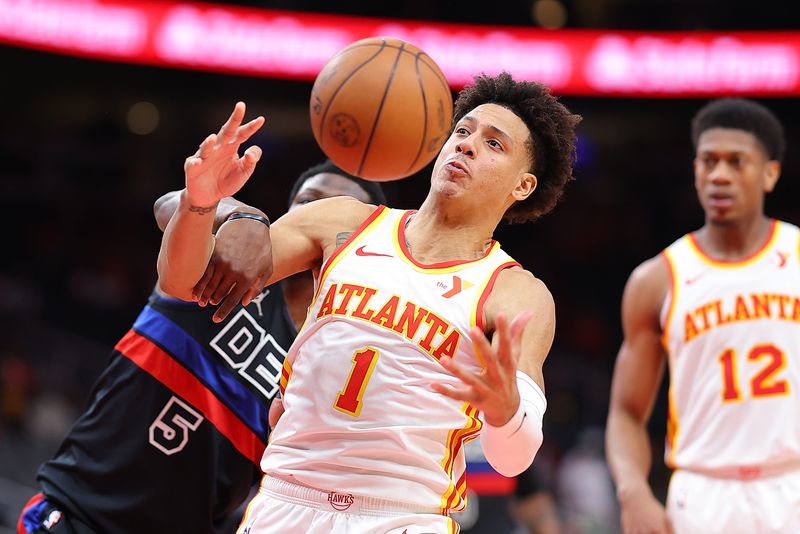 ATLANTA, GEORGIA - APRIL 03:  Jalen Johnson #1 of the Atlanta Hawks grabs a rebound against Jaylen Nowell #5 of the Detroit Pistons during the fourth quarter at State Farm Arena on April 03, 2024 in Atlanta, Georgia.  NOTE TO USER: User expressly acknowledges and agrees that, by downloading and/or using this photograph, user is consenting to the terms and conditions of the Getty Images License Agreement.  (Photo by Kevin C. Cox/Getty Images)