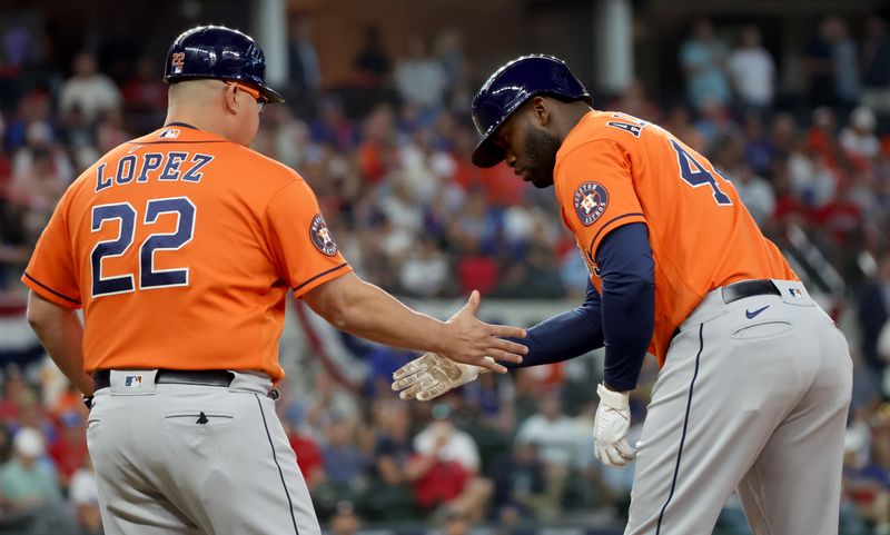 Oct 20, 2023; Arlington, Texas, USA; Houston Astros left fielder Yordan Alvarez (44) celebrates with first base coach Omar Lopez (22) after singling during the first inning of game five in the ALCS against the Texas Rangers for the 2023 MLB playoffs at Globe Life Field. Mandatory Credit: Kevin Jairaj-USA TODAY Sports