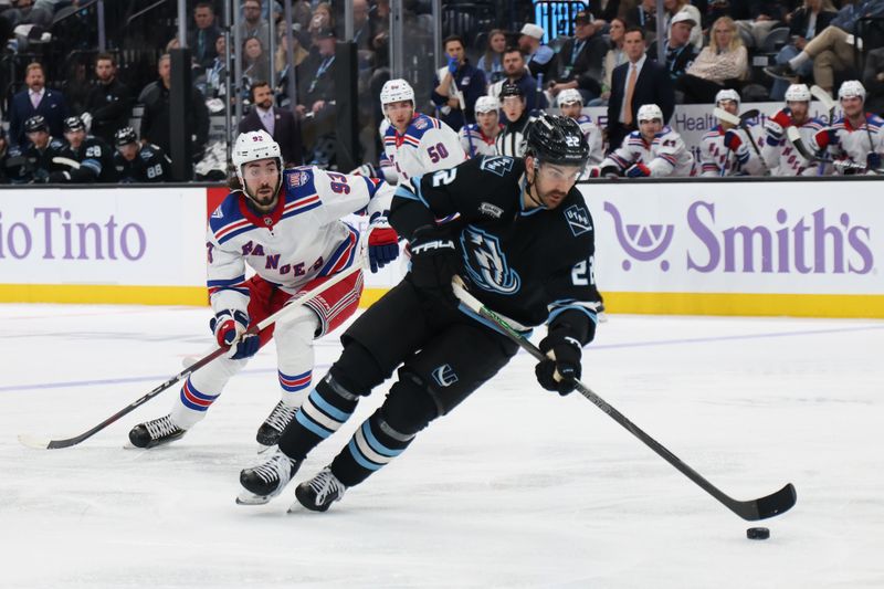 Nov 22, 2025; Salt Lake City, Utah, USA; Utah Mammoth center Jack McBain (22) skates against New York Rangers center Mika Zibanejad (93) during the second period at Delta Center. Mandatory Credit: Rob Gray-Imagn Images