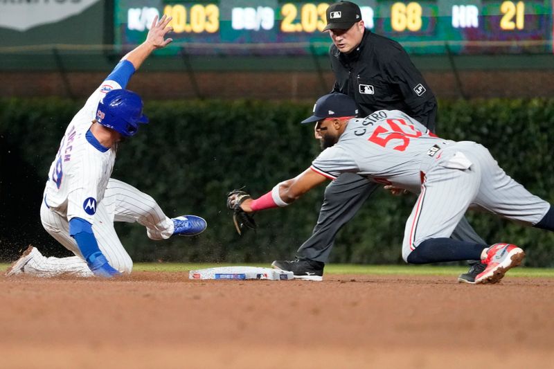 Aug 6, 2024; Chicago, Illinois, USA; Chicago Cubs first baseman Michael Busch (29) is safe at second base as Minnesota Twins shortstop Willi Castro (50) makes a late tag during the fifth inning at Wrigley Field. Mandatory Credit: David Banks-USA TODAY Sports