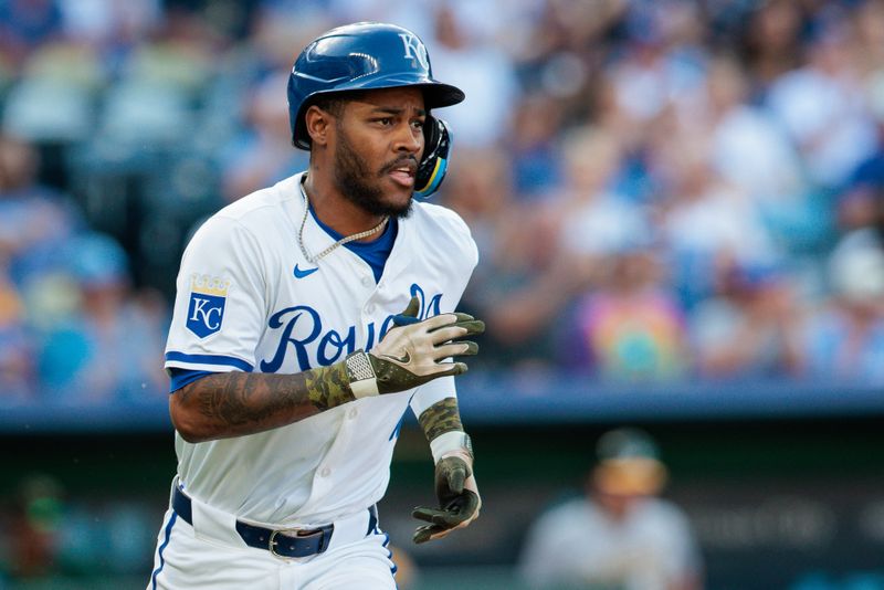 May 18, 2024; Kansas City, Missouri, USA; Kansas City Royals third base Maikel Garcia (11) heads to first base after a base hit during the first inning against the Oakland Athletics at Kauffman Stadium. Mandatory Credit: William Purnell-USA TODAY Sports