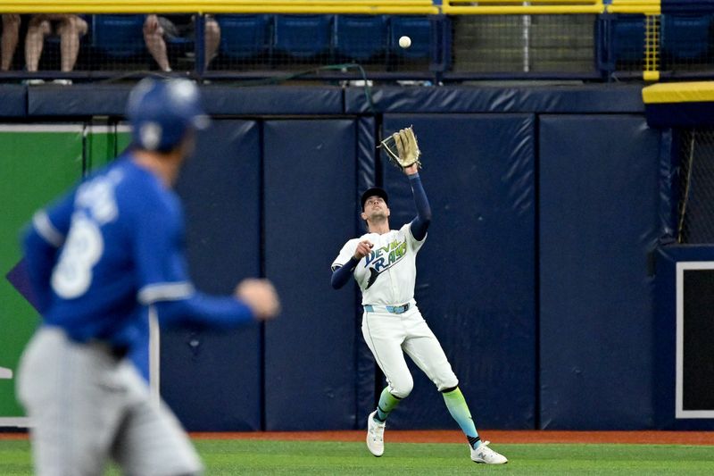 Sep 20, 2024; St. Petersburg, Florida, USA; Tampa Bay Rays right fielder Josh Lowe (15) catches a fly ball in the fourth inning against the Toronto Blue Jays at Tropicana Field. Mandatory Credit: Jonathan Dyer-Imagn Images