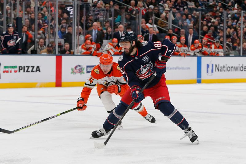 Dec 16, 2025; Columbus, Ohio, USA; Columbus Blue Jackets right wing Kirill Marchenko (86) controls the puck as Anaheim Ducks center Mikael Granlund (64) trails the play during the second period at Nationwide Arena. Mandatory Credit: Russell LaBounty-Imagn Images