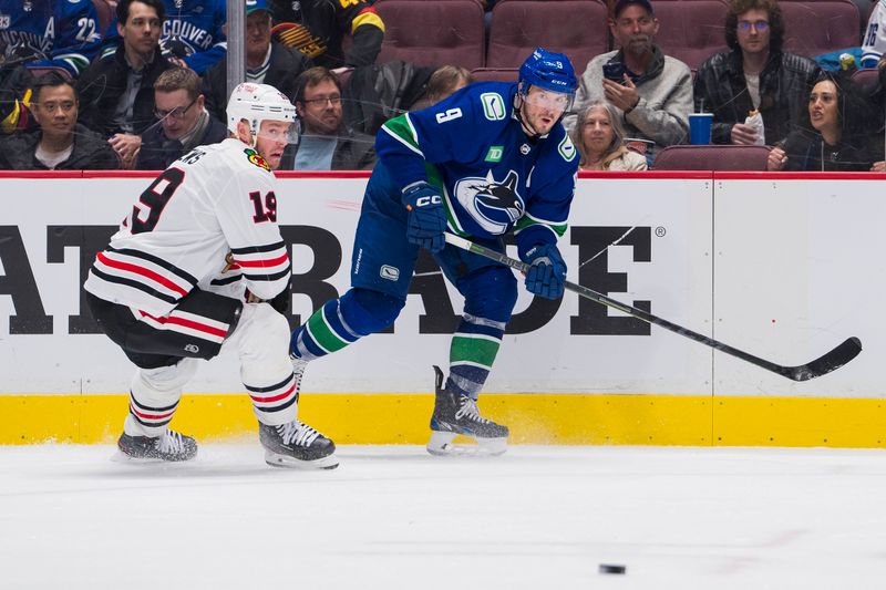 Apr 6, 2023; Vancouver, British Columbia, CAN; Vancouver Canucks forward J.T. Miller (9) makes a pass around Chicago Blackhawks forward Jonathan Toews (19) in the third period at Rogers Arena. Canucks won 3-0. Mandatory Credit: Bob Frid-USA TODAY Sports