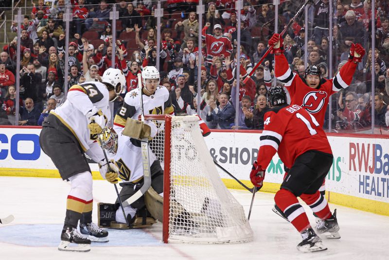 Jan 22, 2024; Newark, New Jersey, USA; New Jersey Devils center Curtis Lazar (42) celebrates his goal past Vegas Golden Knights goaltender Logan Thompson (36) with right wing Nathan Bastian (14) during the third period at Prudential Center. Mandatory Credit: Vincent Carchietta-USA TODAY Sports