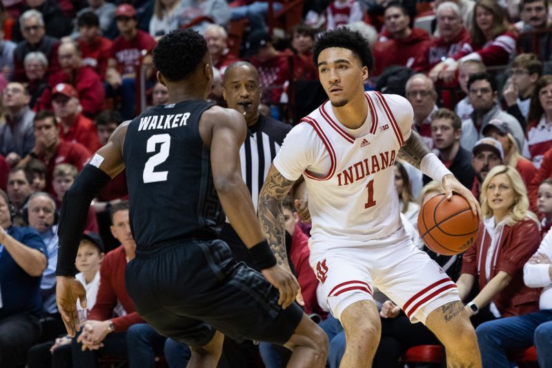 Jan 22, 2023; Bloomington, Indiana, USA; Indiana Hoosiers guard Jalen Hood-Schifino (1) dribbles  the ball while Michigan State Spartans guard Tyson Walker (2) defends in the first half at Simon Skjodt Assembly Hall. Mandatory Credit: Trevor Ruszkowski-USA TODAY Sports