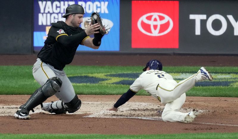 Jul 10, 2024; Milwaukee, Wisconsin, USA; Milwaukee Brewers second base Brice Turang (2) beats the  throw to Pittsburgh Pirates catcher Joey Bart (14) to score on a two-run RBI double by catcher William Contreras during the fourth inning at American Family Field in Milwaukee, Wisconsin.  Mandatory Credit: Mark Hoffman-USA TODAY Sports