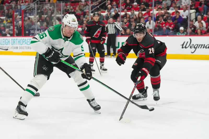 Jan 6, 2026; Raleigh, North Carolina, USA;  Dallas Stars right wing Mikko Rantanen (96) gets the shot past Carolina Hurricanes defenseman Sean Walker (26) during the second period at Lenovo Center. Mandatory Credit: James Guillory-Imagn Images