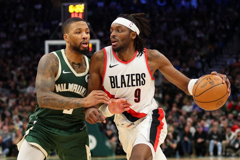 MILWAUKEE, WISCONSIN - NOVEMBER 26: Jerami Grant #9 of the Portland Trail Blazers is defended by Damian Lillard #0 of the Milwaukee Bucks during a game at Fiserv Forum on November 26, 2023 in Milwaukee, Wisconsin. NOTE TO USER: User expressly acknowledges and agrees that, by downloading and or using this photograph, User is consenting to the terms and conditions of the Getty Images License Agreement. (Photo by Stacy Revere/Getty Images)