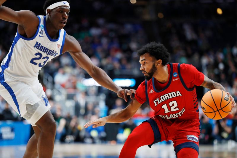 Mar 17, 2023; Columbus, OH, USA; Florida Atlantic Owls guard Jalen Gaffney (12) dribbles the ball defended by Memphis Tigers forward Malcolm Dandridge (23) in the first half at Nationwide Arena. Mandatory Credit: Joseph Maiorana-USA TODAY Sports