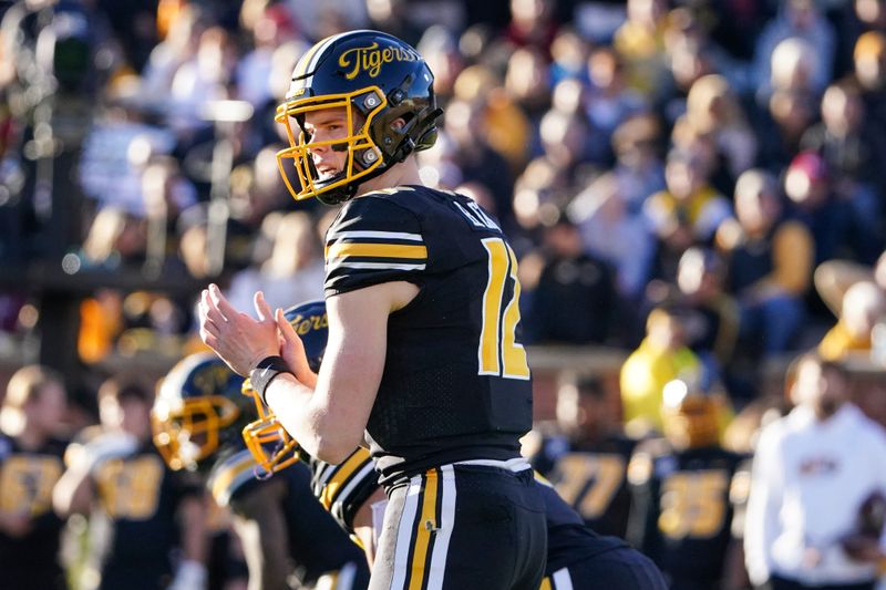 Nov 25, 2022; Columbia, Missouri, USA; Missouri Tigers quarterback Brady Cook (12) readies for the snap against the Arkansas Razorbacks during the first half at Faurot Field at Memorial Stadium. Mandatory Credit: Denny Medley-USA TODAY Sports