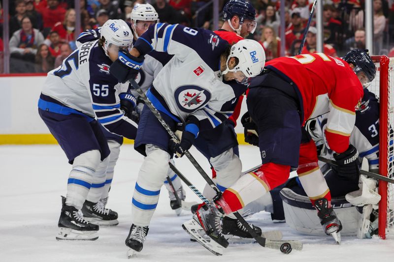 Nov 24, 2023; Sunrise, Florida, USA; Winnipeg Jets left wing Alex Iafallo (9) controls the puck against the Florida Panthers during the second period at Amerant Bank Arena. Mandatory Credit: Sam Navarro-USA TODAY Sports