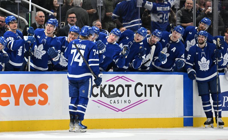 Nov 16, 2024; Toronto, Ontario, CAN;  Toronto Maple Leafs forward Bobby McMann (74) celebrates at the bench after scoring his second goal against the Edmonton Oilers in the third period at Scotiabank Arena. Mandatory Credit: Dan Hamilton-Imagn Images