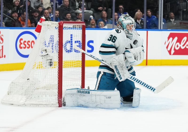 Jan 9, 2024; Toronto, Ontario, CAN; San Jose Sharks goaltender Kaapo Kahkonen (36) stops the puck against the Toronto Maple Leafs during the first period at Scotiabank Arena. Mandatory Credit: Nick Turchiaro-USA TODAY Sports