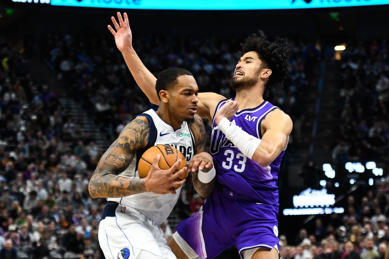 SALT LAKE CITY, UTAH - MARCH 25: P.J. Washington #25 of the Dallas Mavericks drives into Johnny Juzang #33 of the Utah Jazz during the second half of a game at Delta Center on March 25, 2024 in Salt Lake City, Utah. NOTE TO USER: User expressly acknowledges and agrees that, by downloading and or using this photograph, User is consenting to the terms and conditions of the Getty Images License Agreement. (Photo by Alex Goodlett/Getty Images)