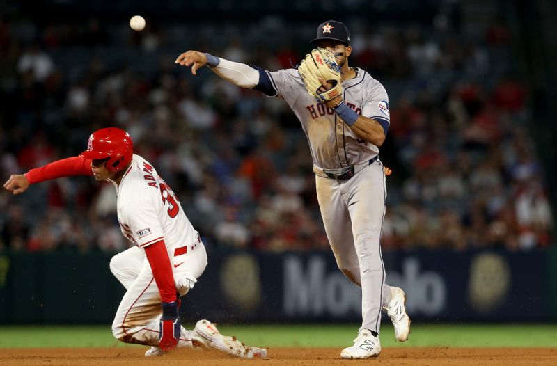 Sep 14, 2024; Anaheim, California, USA; Houston Astros shortstop Jeremy Pena (3) turns a double play to end the game during the 9th inning against Los Angeles Angels outfielder Jordyn Adams (39) at Angel Stadium. Mandatory Credit: Jason Parkhurst-Imagn Images