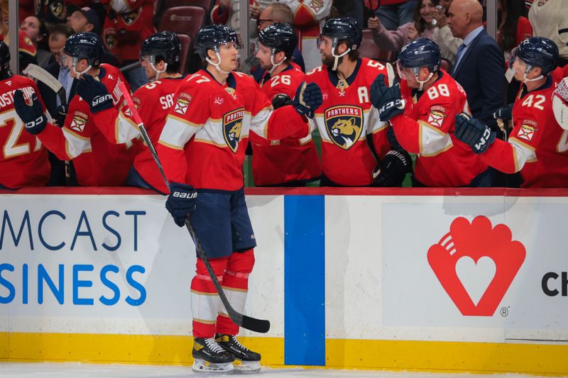 Nov 25, 2024; Sunrise, Florida, USA; Florida Panthers defenseman Niko Mikkola (77) celebrates with teammates after scoring against the Washington Capitals during the first period at Amerant Bank Arena. Mandatory Credit: Sam Navarro-Imagn Images