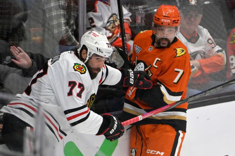 Nov 3, 2024; Anaheim, California, USA;  Chicago Blackhawks left wing Patrick Maroon (77) and Anaheim Ducks defenseman Radko Gudas (7) battle along the boards in the first period at Honda Center. Mandatory Credit: Jayne Kamin-Oncea-Imagn Images