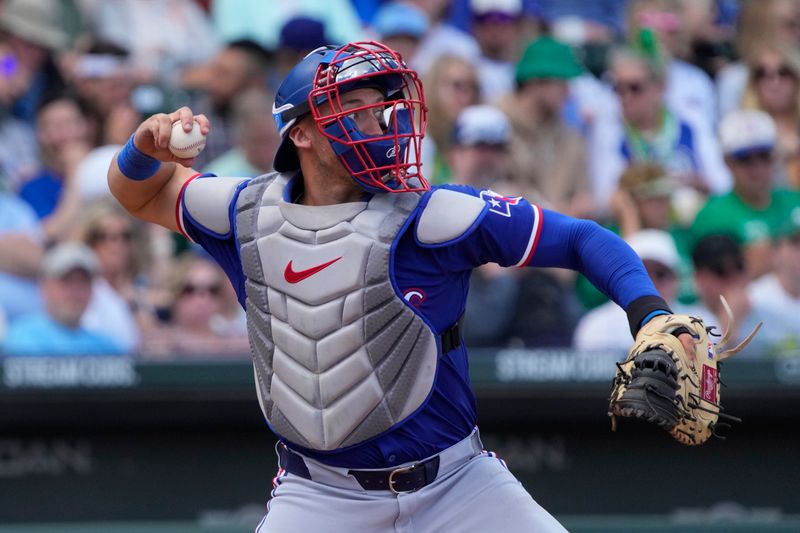 Mar 17, 2024; Mesa, Arizona, USA; Texas Rangers catcher Andrew Knizner (12) makes the play for an out against the Chicago Cubs in the third inning at Sloan Park. Mandatory Credit: Rick Scuteri-USA TODAY Sports