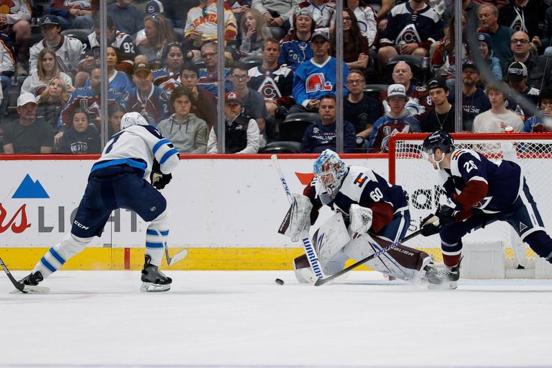 Apr 13, 2024; Denver, Colorado, USA; Winnipeg Jets center Adam Lowry (17) scores on a shot against Colorado Avalanche goaltender Justus Annunen (60) as defenseman Sean Walker (26) defends in the second period at Ball Arena. Mandatory Credit: Isaiah J. Downing-USA TODAY Sports