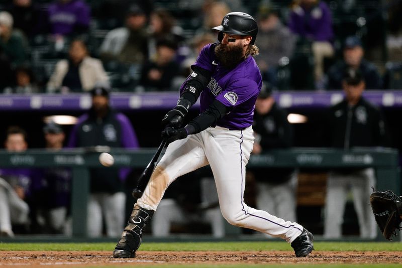 Apr 8, 2024; Denver, Colorado, USA; Colorado Rockies designated hitter Charlie Blackmon (19) hits a solo home run in the eighth inning against the Arizona Diamondbacks at Coors Field. Mandatory Credit: Isaiah J. Downing-USA TODAY Sports