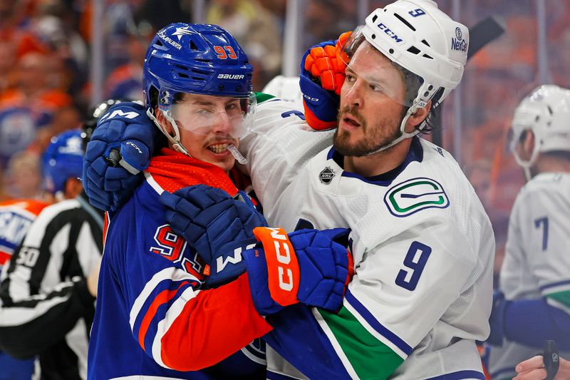 May 12, 2024; Edmonton, Alberta, CAN;Edmonton Oilers forward Ryan Nugent-Hopkins (93) and Vancouver Canucks forward J.T. Miller (9) wrestle during the third period in game three of the second round of the 2024 Stanley Cup Playoffs at Rogers Place. Mandatory Credit: Perry Nelson-USA TODAY Sports