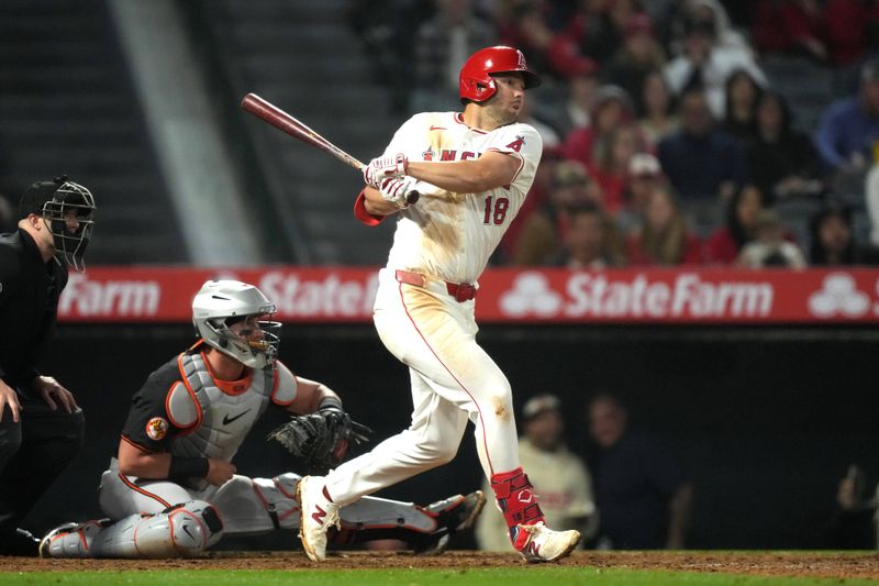 Apr 22, 2024; Anaheim, California, USA; Los Angeles Angels first baseman Nolan Schanuel (18) hits a RBI single in the seventh inning against the Baltimore Orioles at Angel Stadium. Mandatory Credit: Kirby Lee-USA TODAY Sports