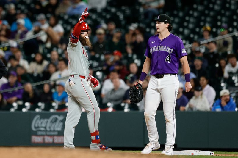 May 20, 2025; Denver, Colorado, USA; Philadelphia Phillies center fielder Brandon Marsh (16) reacts ahead of Colorado Rockies first baseman Michael Toglia (4) after hitting a single in the ninth inning at Coors Field. Mandatory Credit: Isaiah J. Downing-Imagn Images