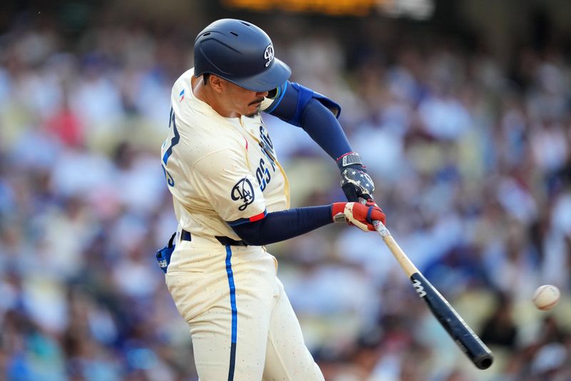 Jul 6, 2024; Los Angeles, California, USA; Los Angeles Dodgers left fielder Miguel Vargas (27) hits a home run in the eighth inning against the Milwaukee Brewers at Dodger Stadium. Mandatory Credit: Kirby Lee-USA TODAY Sports