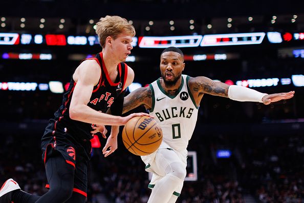 TORONTO, CANADA - NOVEMBER 15: Gradey Dick #1 of the Toronto Raptors is defended by Damian Lillard #0 of the Milwaukee Bucks as he dribbles during the first half of their NBA game at Scotiabank Arena on November 15, 2023 in Toronto, Canada. NOTE TO USER: User expressly acknowledges and agrees that, by downloading and or using this photograph, User is consenting to the terms and conditions of the Getty Images License Agreement. (Photo by Cole Burston/Getty Images)