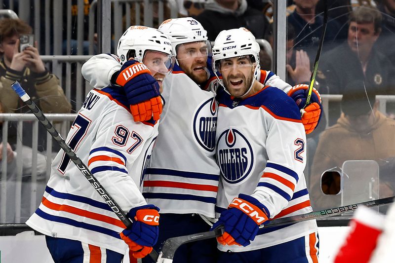 Mar 5, 2024; Boston, Massachusetts, USA; Edmonton Oilers center Leon Draisaitl (29) celebrates his game winning overtime goal against the Boston Bruins with teammates center Connor McDavid (97) and defenseman Evan Bouchard (2) at TD Garden. Mandatory Credit: Winslow Townson-USA TODAY Sports