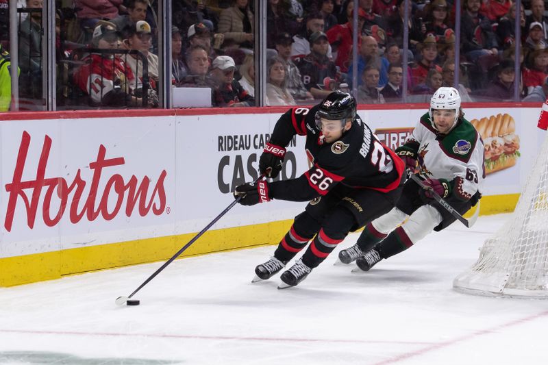 Mar 1, 2024; Ottawa, Ontario, CAN; Ottawa Senators defenseman Erik Brannstrom (26) skates with the puck in front of Arizona Coyotes left wing Matias Maccelli (63) in the second period at the Canadian Tire Centre. Mandatory Credit: Marc DesRosiers-USA TODAY Sports