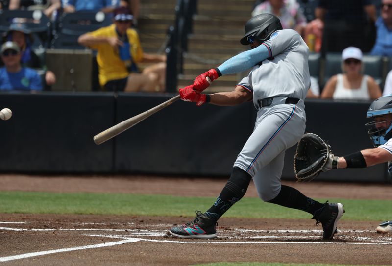 Jun 8, 2025; St. Petersburg, Florida, USA;  Miami Marlins infielder Otto Lopez (6) hits an RBI single against the Tampa Bay Rays during the first inning at George M. Steinbrenner Field. Mandatory Credit: Kim Klement Neitzel-Imagn Images