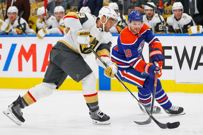 Apr 10, 2024; Edmonton, Alberta, CAN; Vegas Golden Knights defensemen Alec Martinez (23) and Edmonton Oilers forward Zach Hyman (18) battle for a loose puck during the third period at Rogers Place. Mandatory Credit: Perry Nelson-USA TODAY Sports